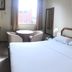 Hotel Grão Para in Belém guest room with double bed, TV, desk, and small seating area