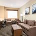 Wyndham Anaheim Hotel in Anaheim guest room with sofa, desk, chair, wall art, and window