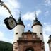 Hotel Goldener Hecht in Heidelberg: historic tower gate with twin domes against a blue sky