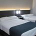 Motel 6-West Des Moines, IA guest room with two double beds and bedside lamp