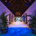 Maradiva Villas Resort & Spa in Flic en Flac, tropical resort corridor with potted palms and ocean view