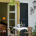 Churfuerstliche Waldschaenke in Moritzburg with a patio table, chairs, open shutters and doorway
