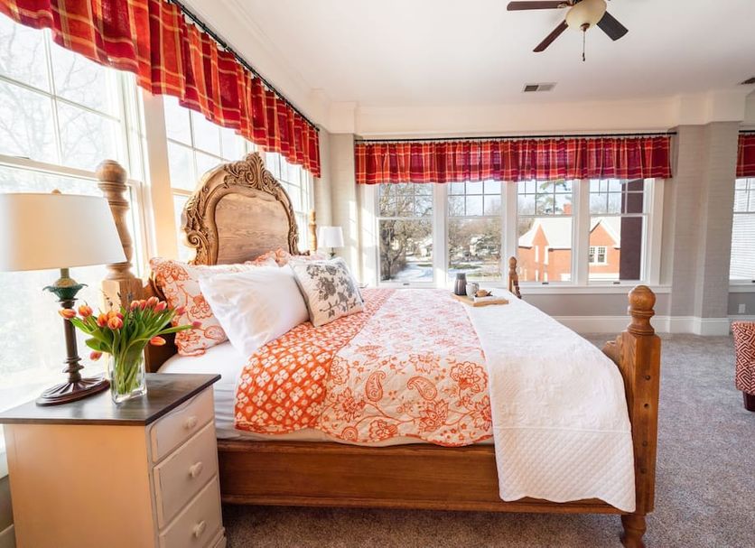 The Nordic Pineapple Bed and Breakfast in Saint Johns room with carved wood bed and large windows