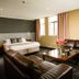The Grosvenor in Timaru guest room with king bed, leather seating, coffee table and windows