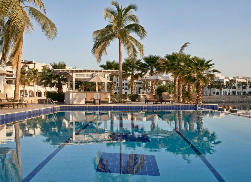 Juweira Boutique Hotel - Adults only in Salalah, palm-lined pool with waterfront reflections