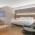 Radisson Plaza Hotel at Kalamazoo Center room with king bed, sofa, and seating area in Kalamazoo