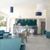 Hotel La Voile lobby lounge in Bormes-les-Mimosas with teal chairs, bar seating and bright modern decor