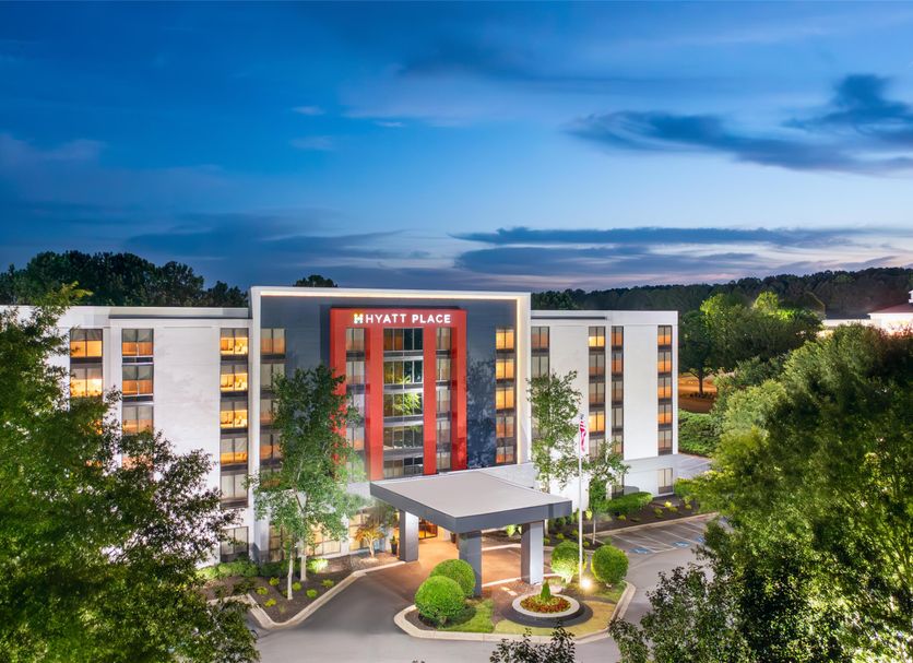 Hyatt Place Atlanta/Alpharetta/North Point Mall exterior in Alpharetta at dusk with lit entrance