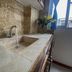 Aqua Resort in Diani Beach bathroom sink with stone countertop, chrome faucet, and window view