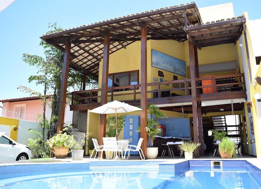 Encanto de Itapoan Pousada in Salvador with a poolside patio and two-story balcony