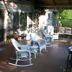 Chalet of Canandaigua porch with wicker rocking chairs and seating on a covered deck in Canandaigua
