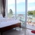 Hai Yen Family Resort in Phan Thiet: bedroom with bed, rose petals, and ocean-view balcony