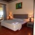 Bali Lovina Beach Cottages in Buleleng guest room with king bed, bedside lamps, and balcony view