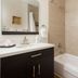 Hotel Flora and Fauna bathroom in Wimberley with vanity, mirror, tub and shower area