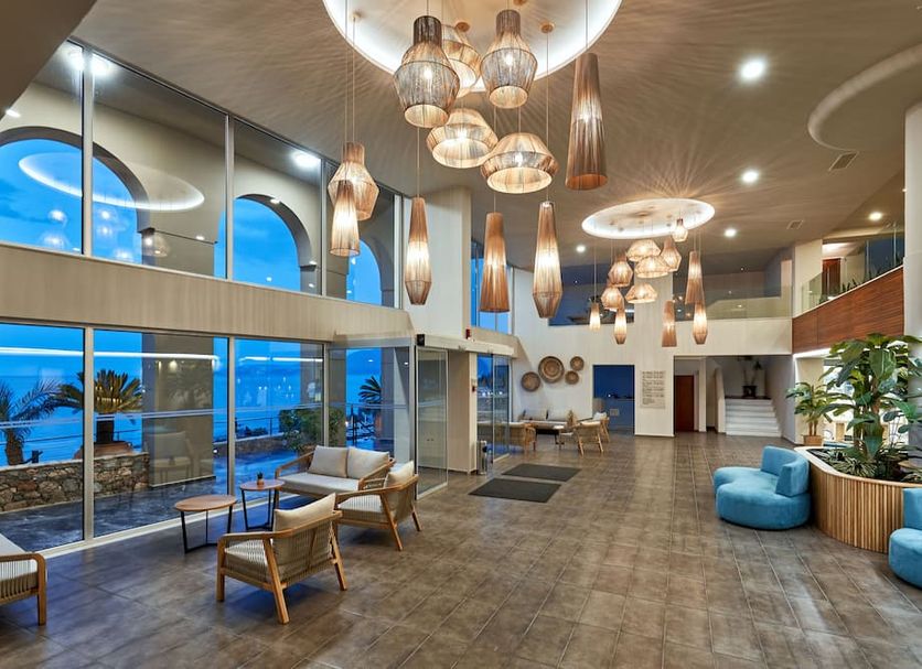 Blue Marine Resort & Spa in Agios Nikolaos lobby with sea views, hanging lights, and seating area
