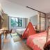 Home2 Suites by Hilton Xishuangbanna Jinghong room with teepee tent, sofa, desk and large window