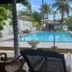 Mother's Place Nimala in Hikkaduwa with a palm-lined outdoor pool and lounge chairs