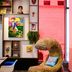 citizenM Austin Downtown lounge with colorful wall art, a furry chair and pink-lit wall
