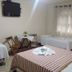 Hotel Vale Verde Penedo room with multiple single beds, TV, and window curtains in Penedo