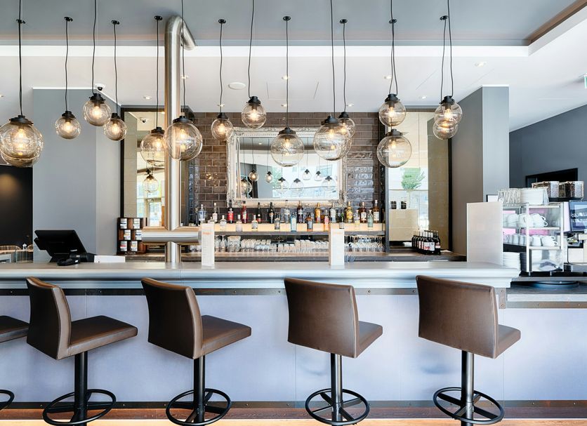 Premier Inn Lübeck City Centre bar with pendant lights and high stools in Lübeck