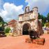 Hotel Suria Malaqa in Malacca with historic stone gate and cannons in a courtyard