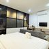The Yak Cozy Chiang Mai guest room in Chiang Mai with bed, sofa, desk, TV and balcony door