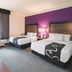 La Quinta Inn & Suites by Wyndham Fort Worth City View room with two beds and purple accent wall