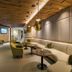 Almwellness Hotel Pierer in Fladnitz lounge with curved beige seating, green armchairs and pendant lights