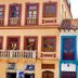El Cafecito Hostel Cuenca in Cuenca, colorful colonial facade with balconies and tiled roof