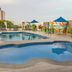 Howard Johnson by Wyndham Barranquilla Versalles rooftop pool deck with lounge chairs and umbrellas