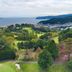 Atami Club Geihinkan in Atami overlooks lush gardens and coastline with a sweeping ocean view.