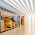 Binhai Jianguo Hotel in Tianjin lobby corridor with striped ceiling and open lounge seating