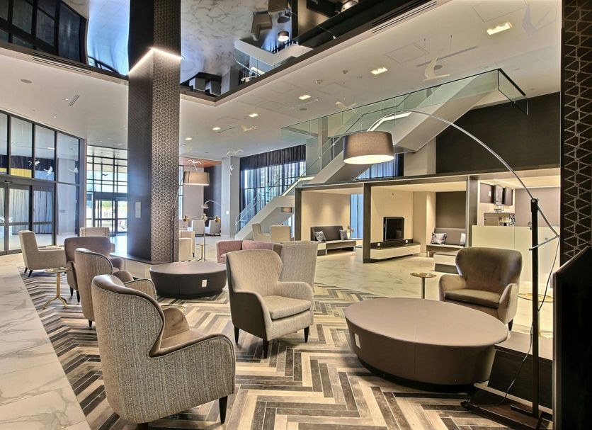 Courtyard by Marriott Montreal Brossard lobby with seating area and modern staircase in Brossard