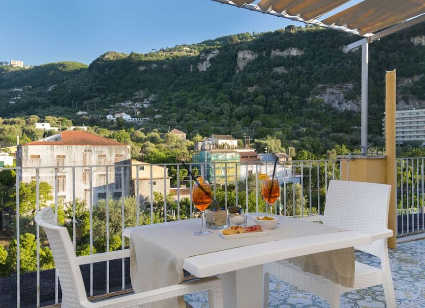 Hotel Leone in Sorrento terrace dining table with mountain and hillside views