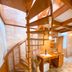Pousada O Cantinho da Raposa in Monte Verde, spiral wooden staircase and kitchenette with brick walls