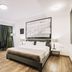 Hotel Citadel Narikala room with king bed, seating area, and large window in Tbilisi