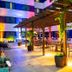 Viale Cataratas Hotel & Eventos in Foz do Iguaçu, lit outdoor patio with pergola seating and potted plants