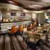 Marriott Jacksonville Downtown restaurant seating area in Jacksonville with booths, tables and warm lighting