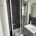 Contact Hôtel les Platanes Villeneuve sur Lot Centre bathroom with shower, sink and wall-mounted hairdryer