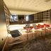 ibis Haguenau Strasbourg Nord lounge with red and black chairs, round tables, and mirrored wall in Haguenau