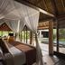 Kayumanis Jimbaran Private Estate & Spa in South Kuta bedroom with canopy bed and pool view