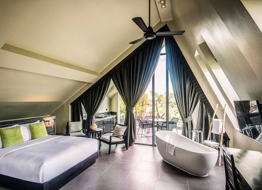 Anjali by Syphon Siem Reap suite with king bed, freestanding tub and balcony garden view