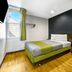 Studio 6 Portland Or room with bed, desk, black accent wall and window in Portland