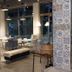 Pohang Youngildae Guesthouse lounge with white tables, chairs, pendant lights and large windows in Pohang
