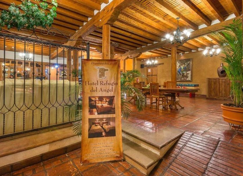 Hotel Refugio del Angel in Pátzcuaro, rustic lobby with wood beams, tiled floors and seating
