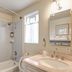 The Tides Laguna Beach bathroom with tub-shower, sink vanity, mirror and window in Laguna Beach