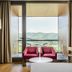Exe Las Margas Golf Hotel in Latas room with balcony and mountain views, two pink chairs and desk