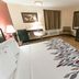 Red Roof Inn Raleigh Southwest - Cary room with king bed, desk, TV and mini fridge in Cary