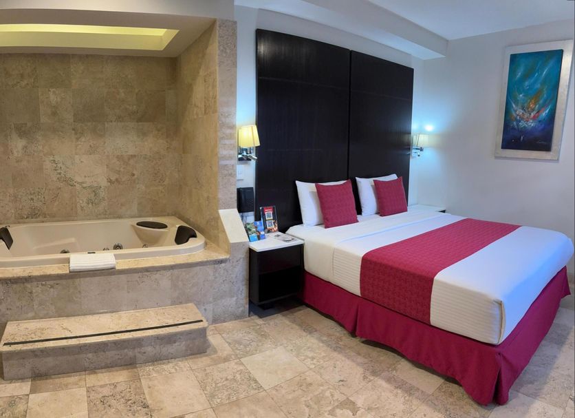 Hotel Del Pescador Ajijic guest room with king bed and built-in soaking tub