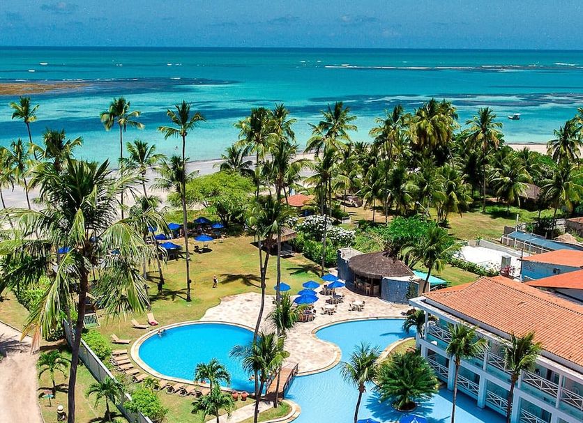 Baia Branca Beach Resort in Porto de Galinhas with pool, palm trees, and oceanfront beach view
